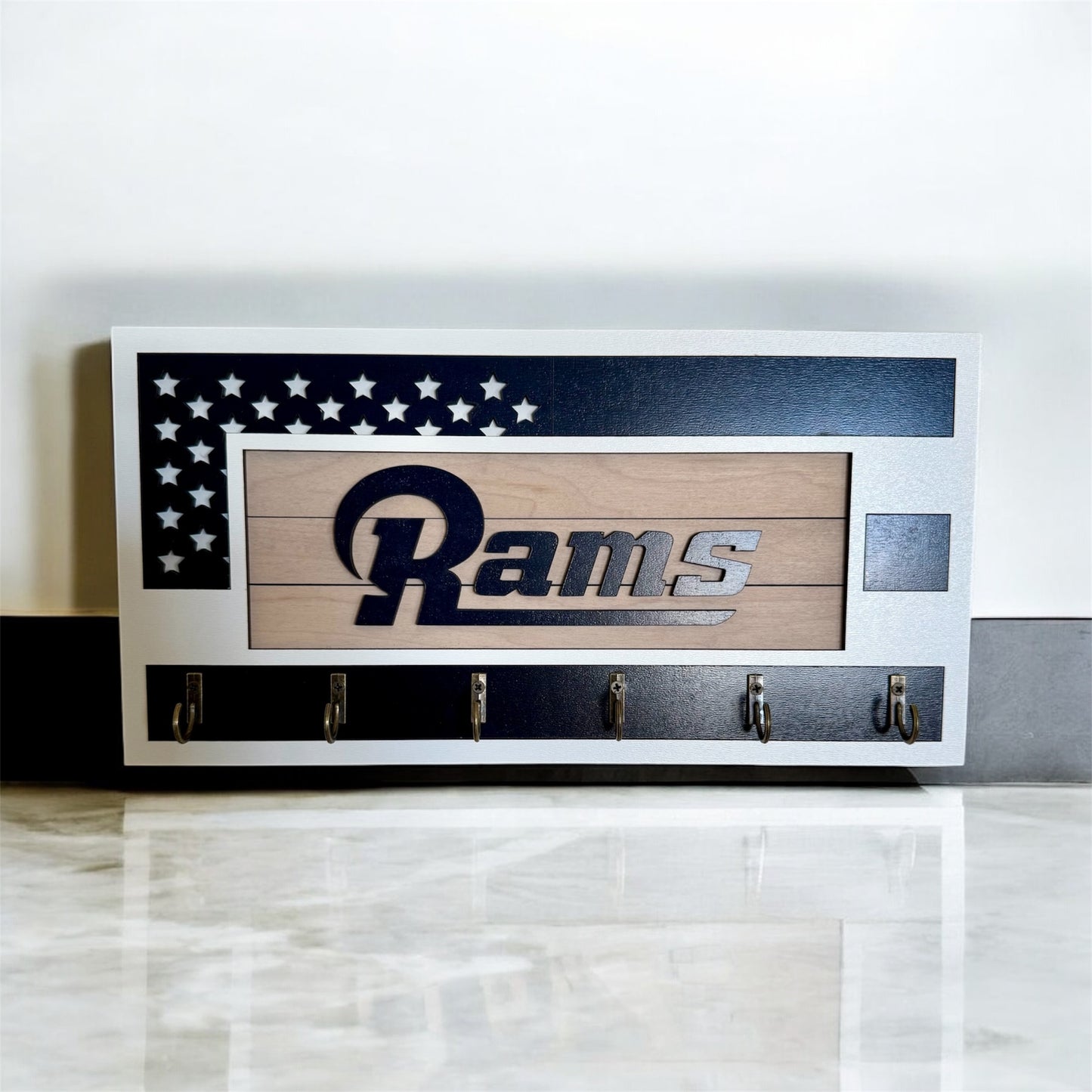 Los Angeles Rams home key holder that is white and blue with 6 hooks.