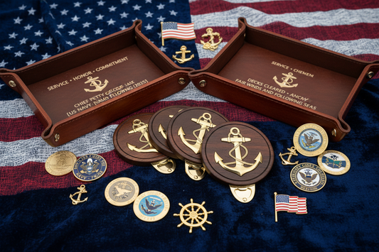 Personalized Navy retirement ceremony guest gifts including custom bottle opener coasters with Chief anchors, engraved catch-all trays, and challenge coins displayed on navy blue background