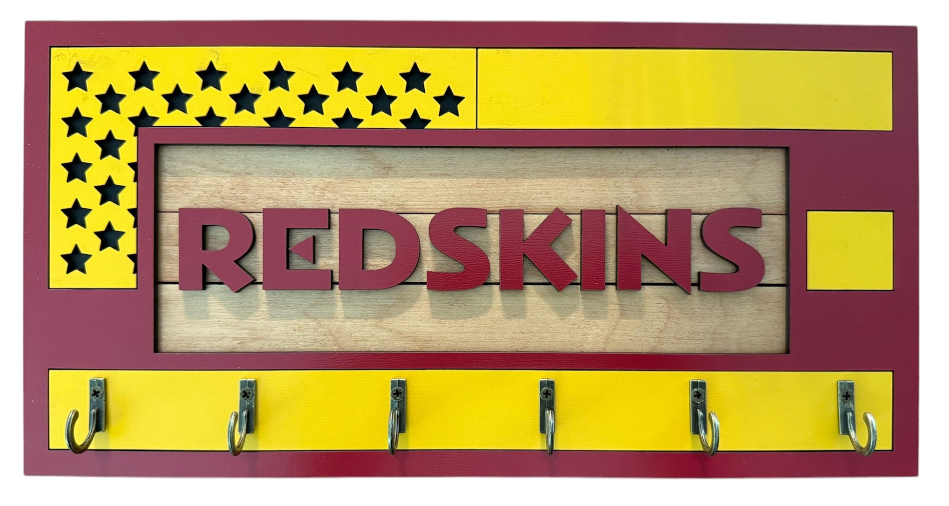 USA flag-inspired wooden key holder with “Redskins” in maroon letters, featuring yellow and maroon accents, six metal hooks, and a rustic maple wood background.
