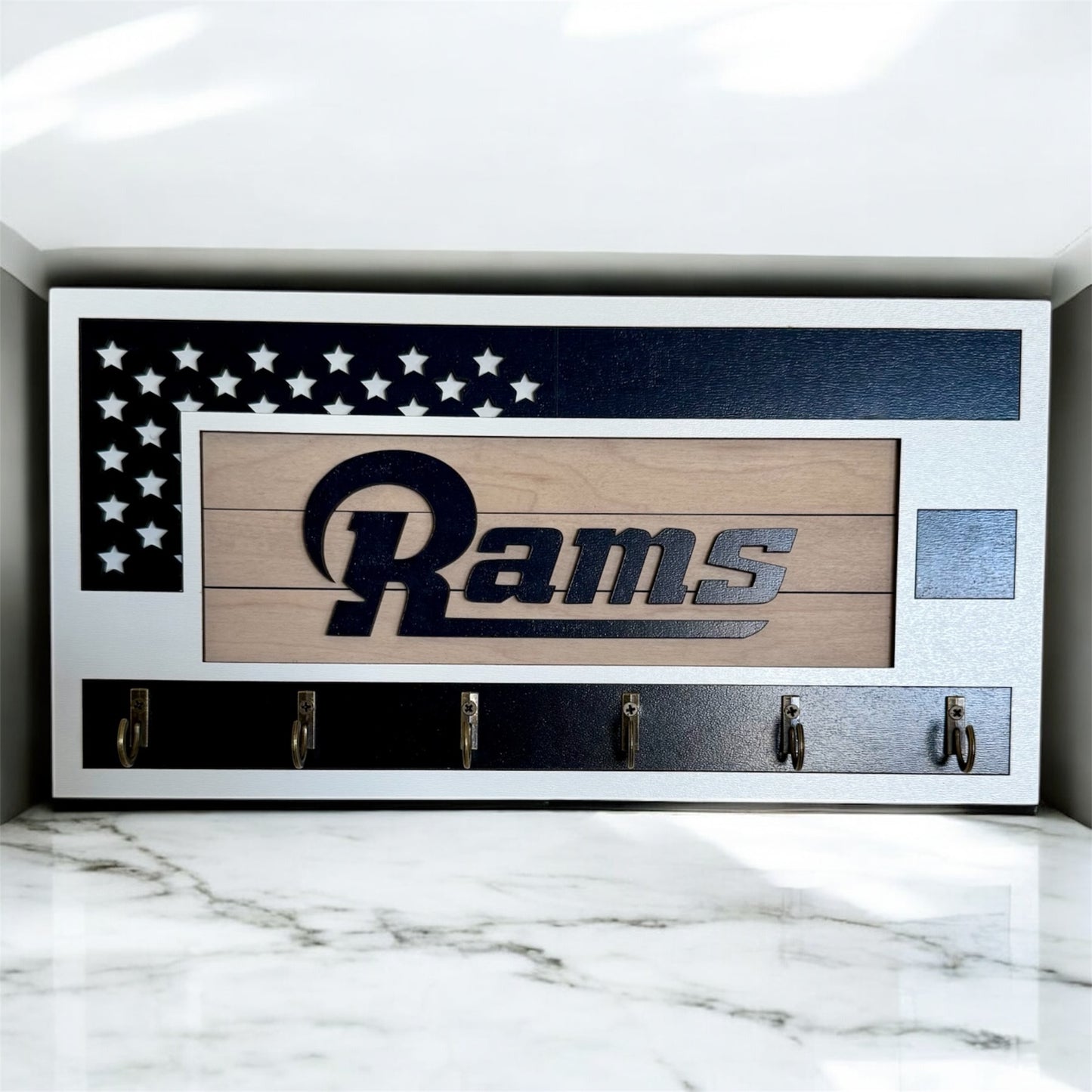 Los Angeles Rams home key holder that is white and blue with 6 hooks.