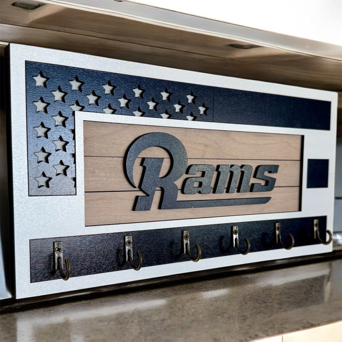 Los Angeles Rams home key holder that is white and blue with 6 hooks.