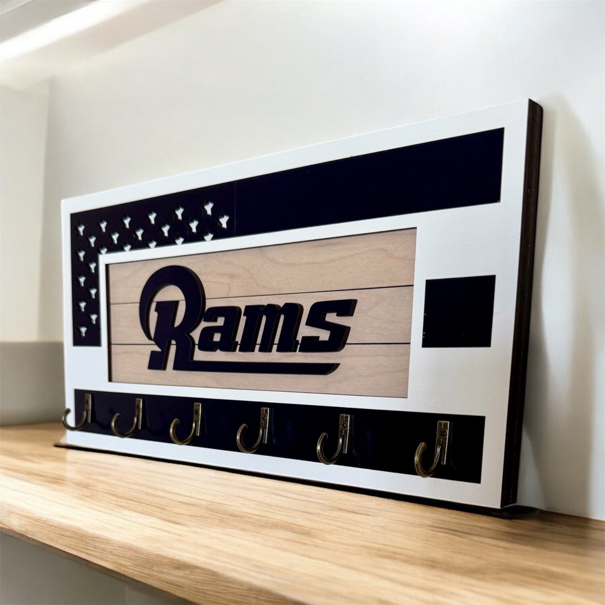 Los Angeles Rams home key holder that is white and blue with 6 hooks.
