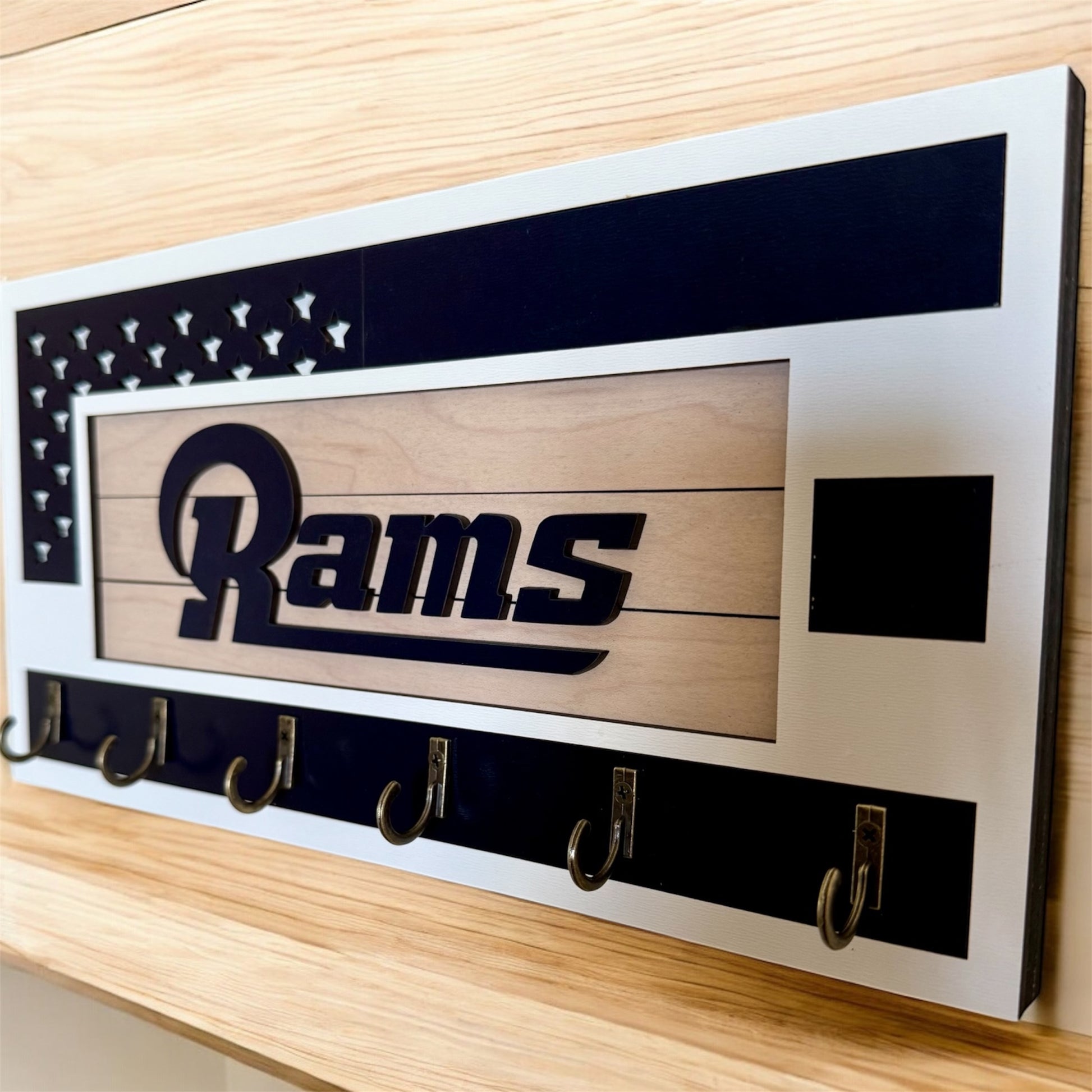 Los Angeles Rams home key holder that is white and blue with 6 hooks.