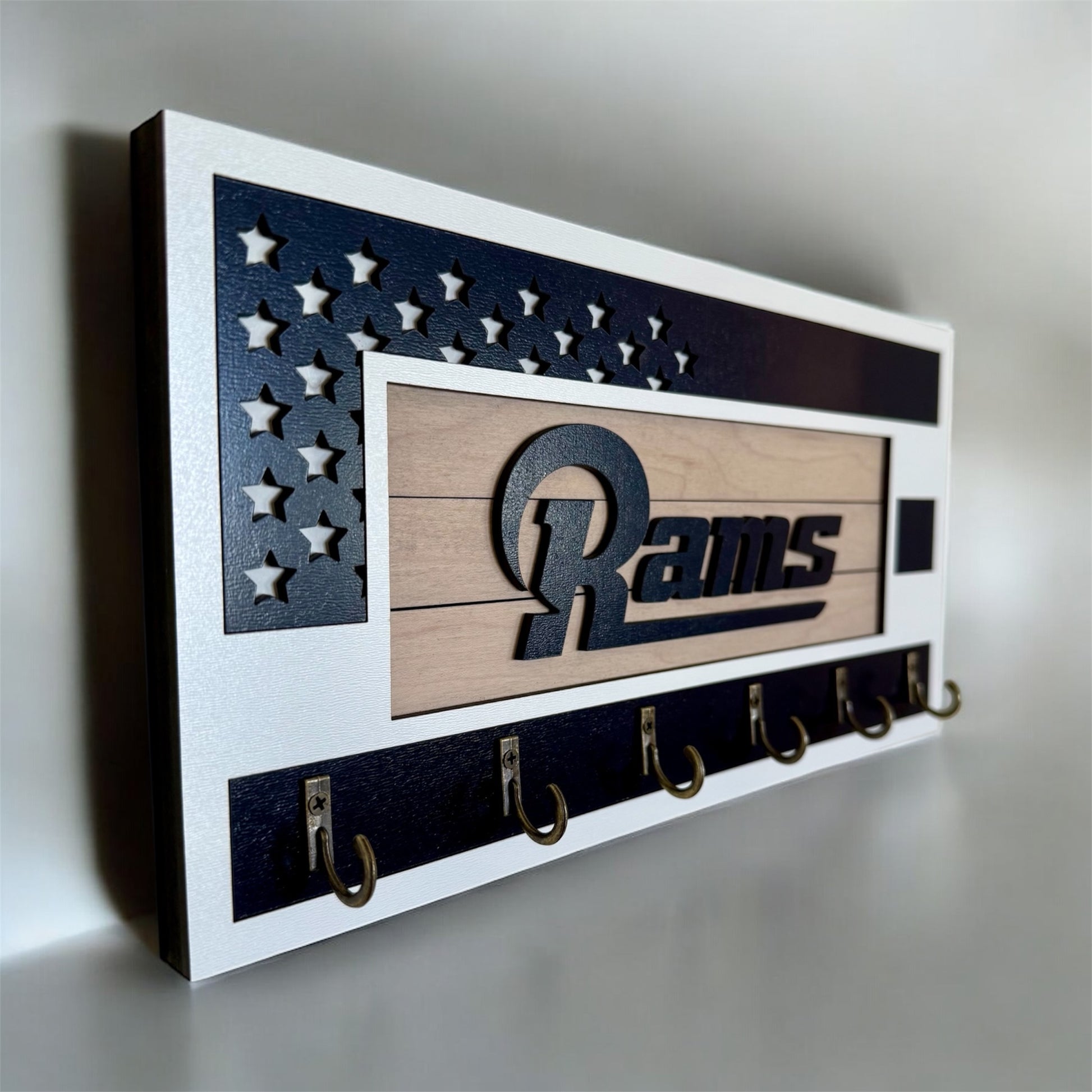 Los Angeles Rams home key holder that is white and blue with 6 hooks.