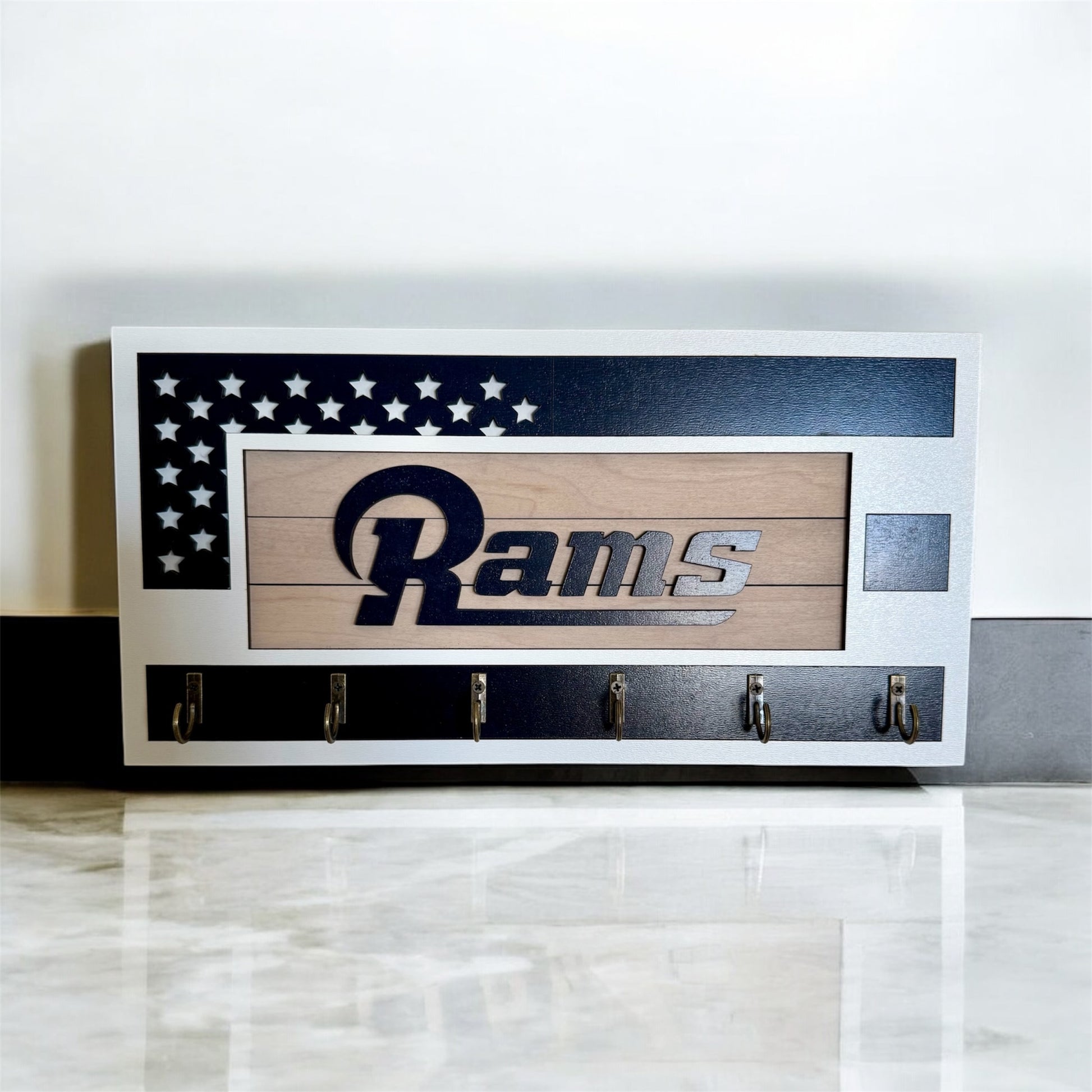 Los Angeles Rams home key holder that is white and blue with 6 hooks.