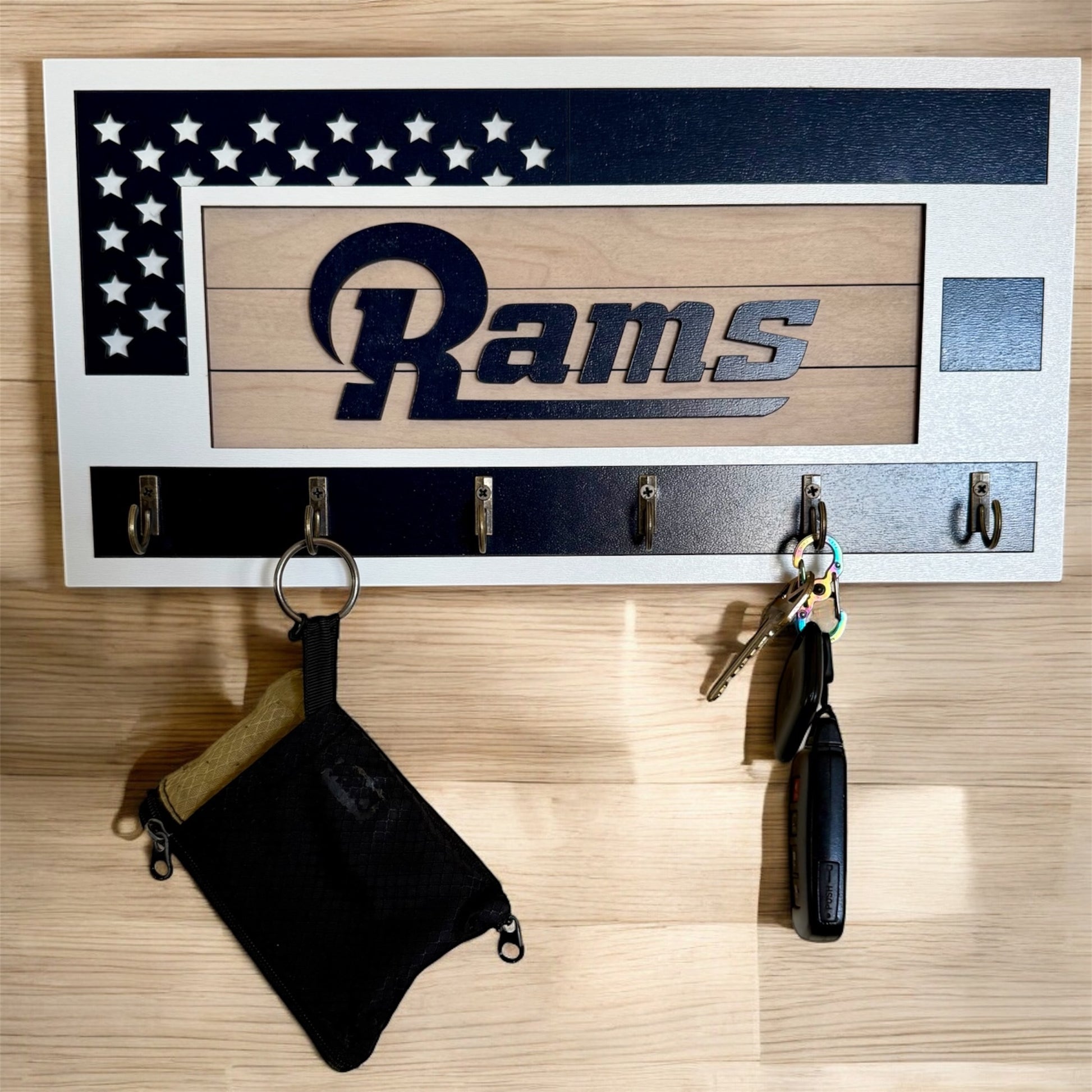 Los Angeles Rams home key holder that is white and blue with 6 hooks.