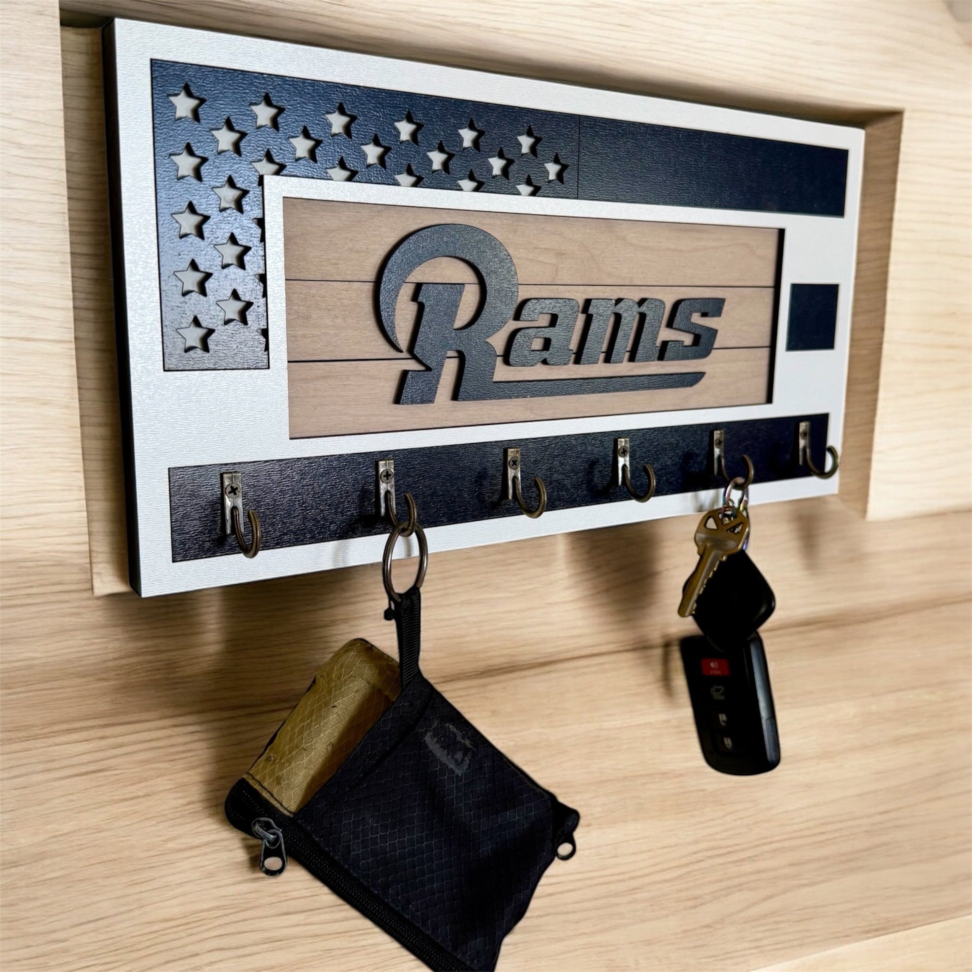 Los Angeles Rams home key holder that is white and blue with 6 hooks.