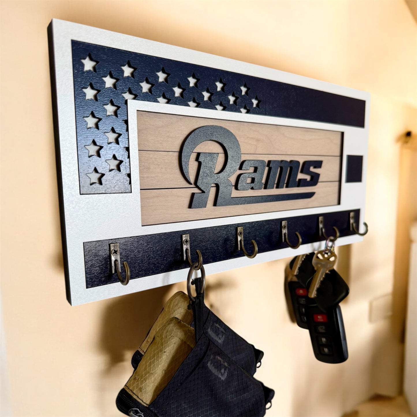 Los Angeles Rams home key holder that is white and blue with 6 hooks.