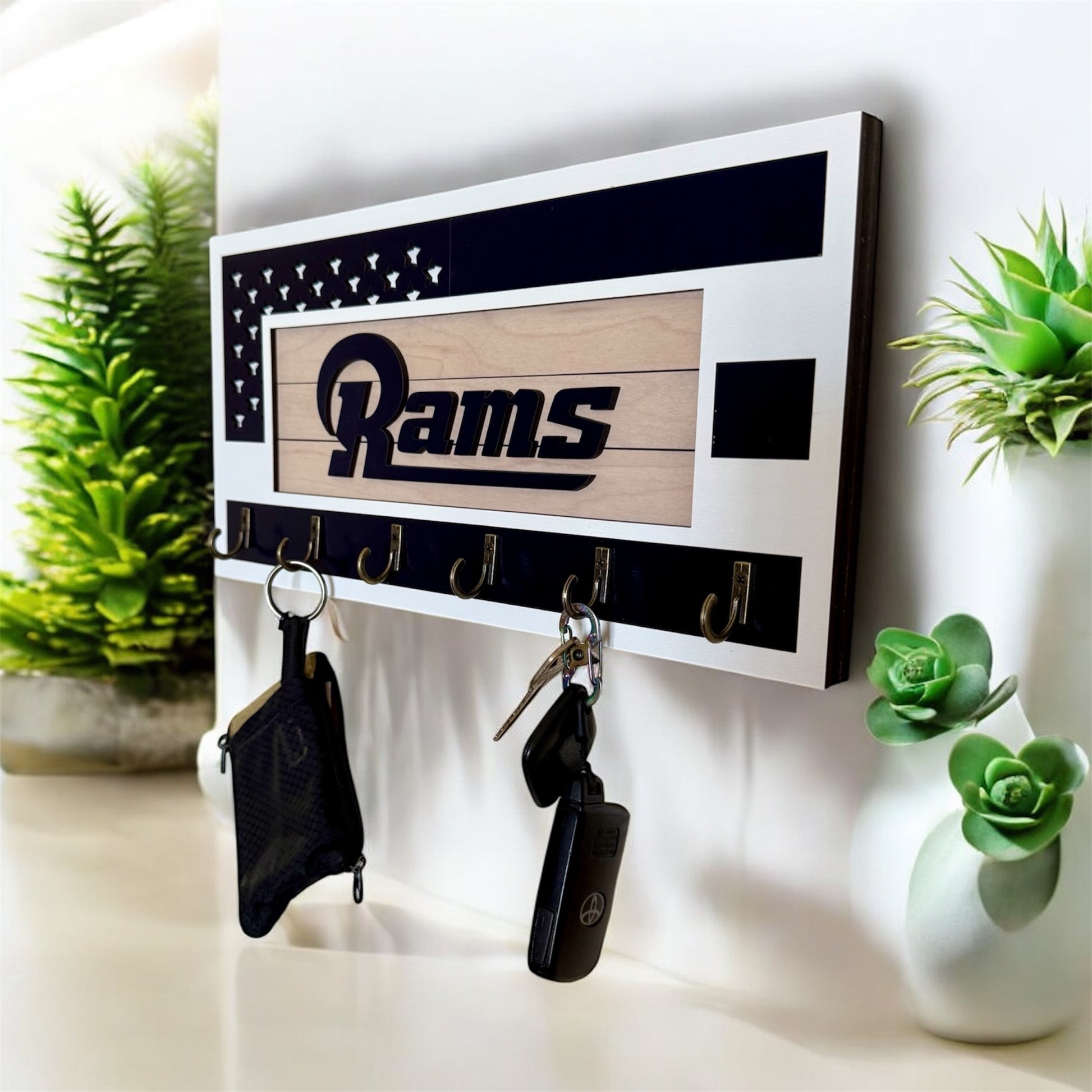 Los Angeles Rams home key holder that is white and blue with 6 hooks.