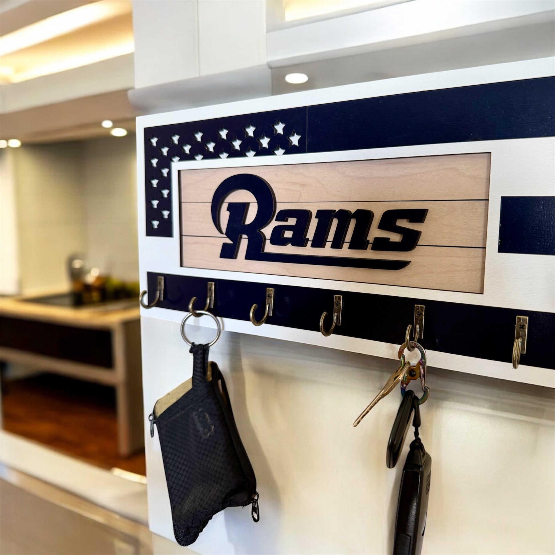 Los Angeles Rams home key holder that is white and blue with 6 hooks.