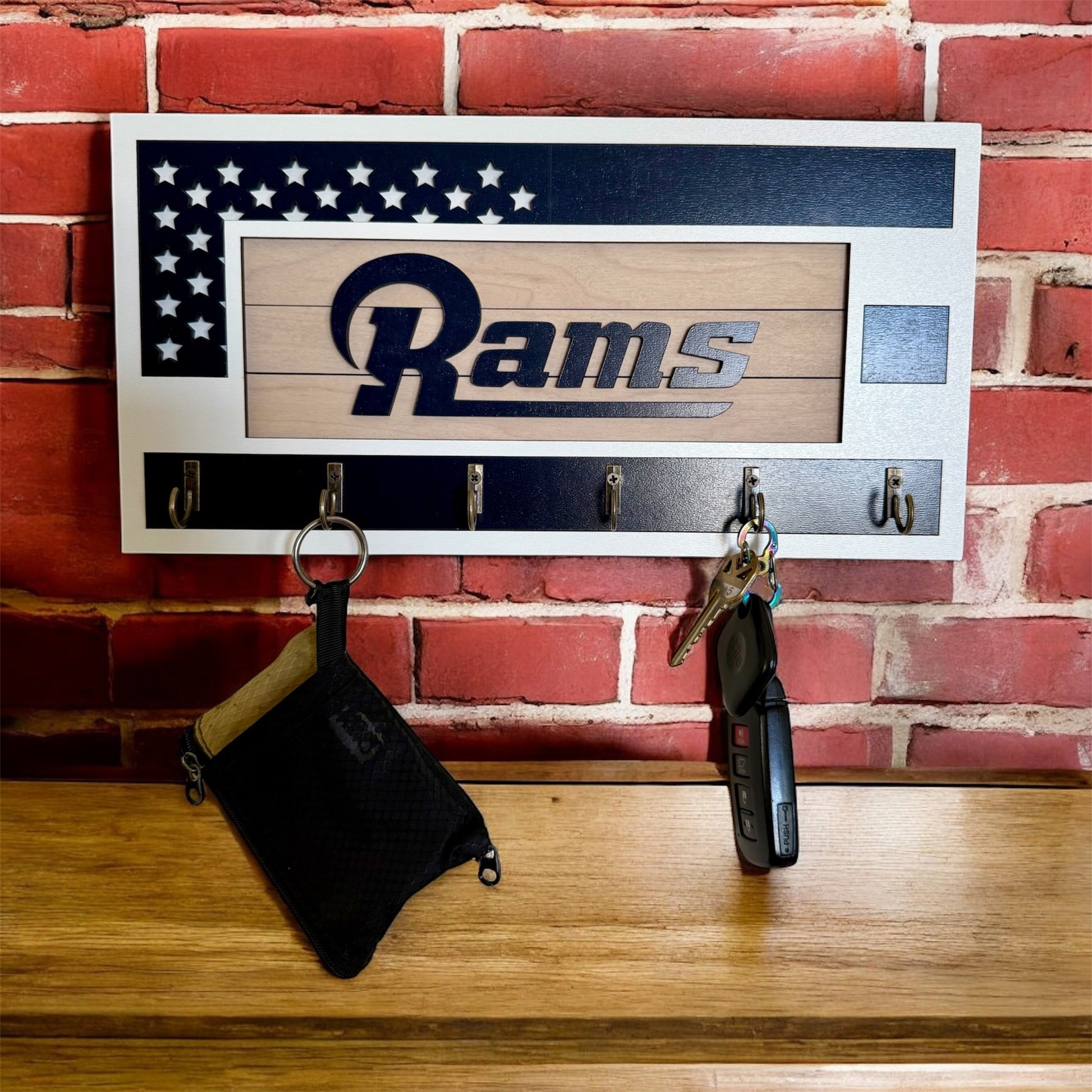 Los Angeles Rams home key holder that is white and blue with 6 hooks.